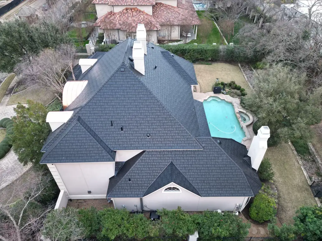 Aerial view of a new dark shingle roof installed by Dimensional Pro Construction