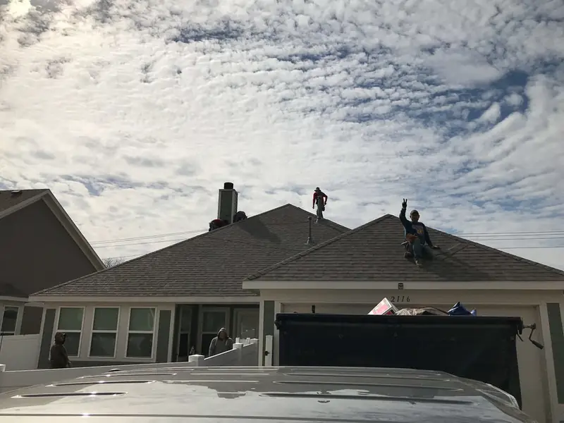 Dimensional Pro Construction crew working on a roof replacement