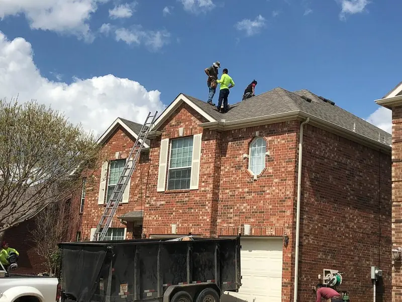 Dimensional Pro Construction crew working on a roof replacement