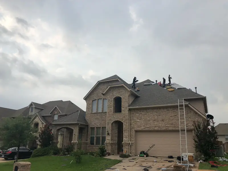 Dimensional Pro Construction crew working on a roof replacement