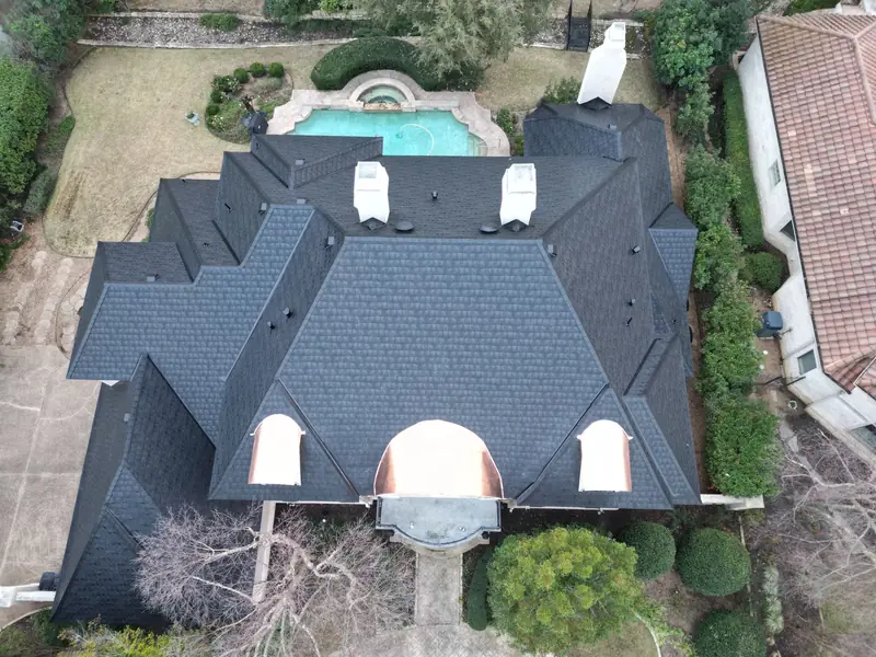 Aerial view of a new roof installed by Dimensional Pro Construction