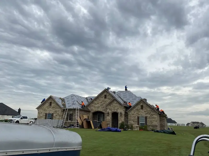 Dimensional Pro Construction crew working on a roof replacement