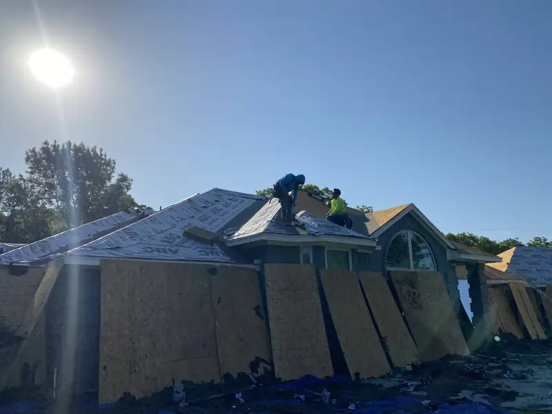 Dimensional Pro Construction crew working on a roof replacement