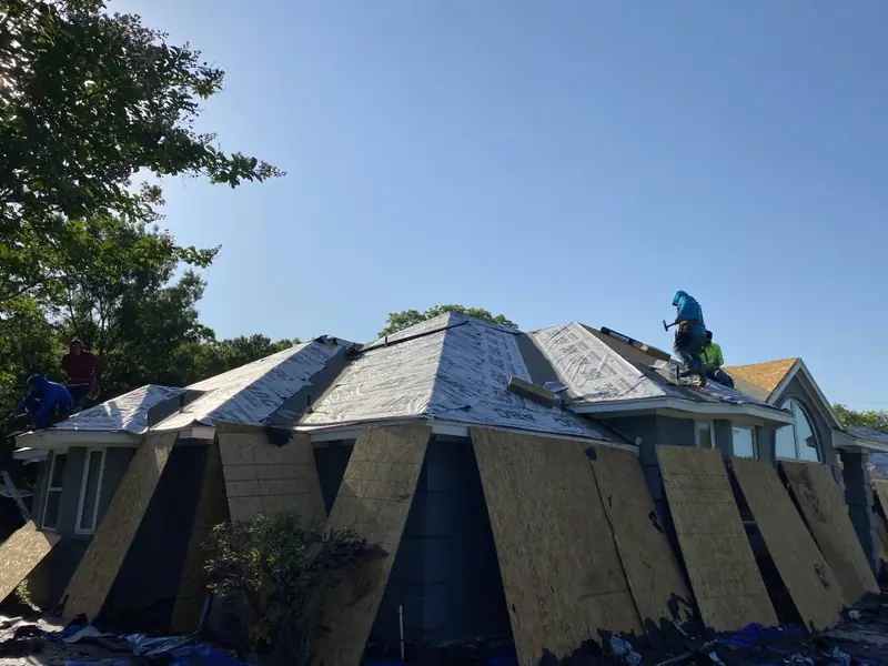 Dimensional Pro Construction crew working on a roof replacement