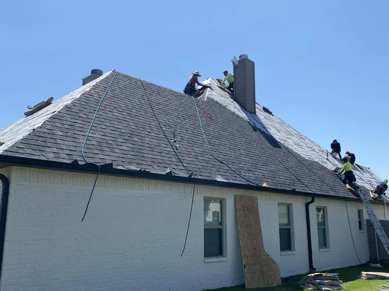 Dimensional Pro Construction crew working on a roof replacement