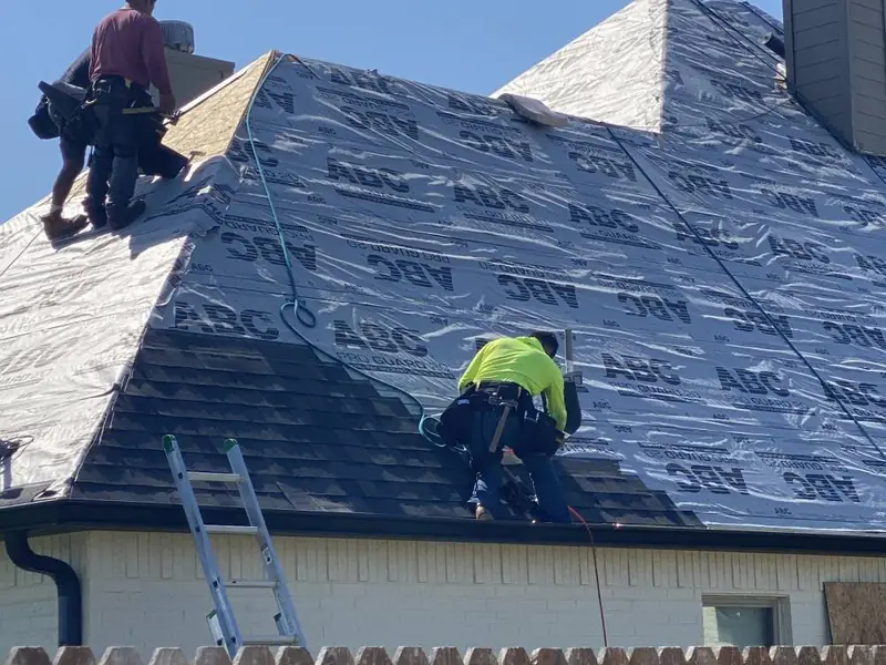 Dimensional Pro Construction crew working on a roof replacement