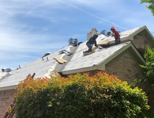 Workers fixing A frame roof