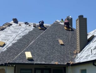 Picture of workers redoing asphalt roof