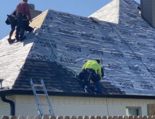 Picture of workers redoing asphalt roof