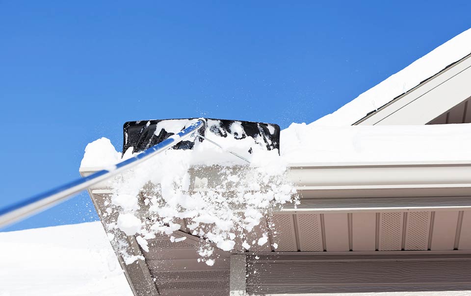 Picture of snow being scrapped off roof